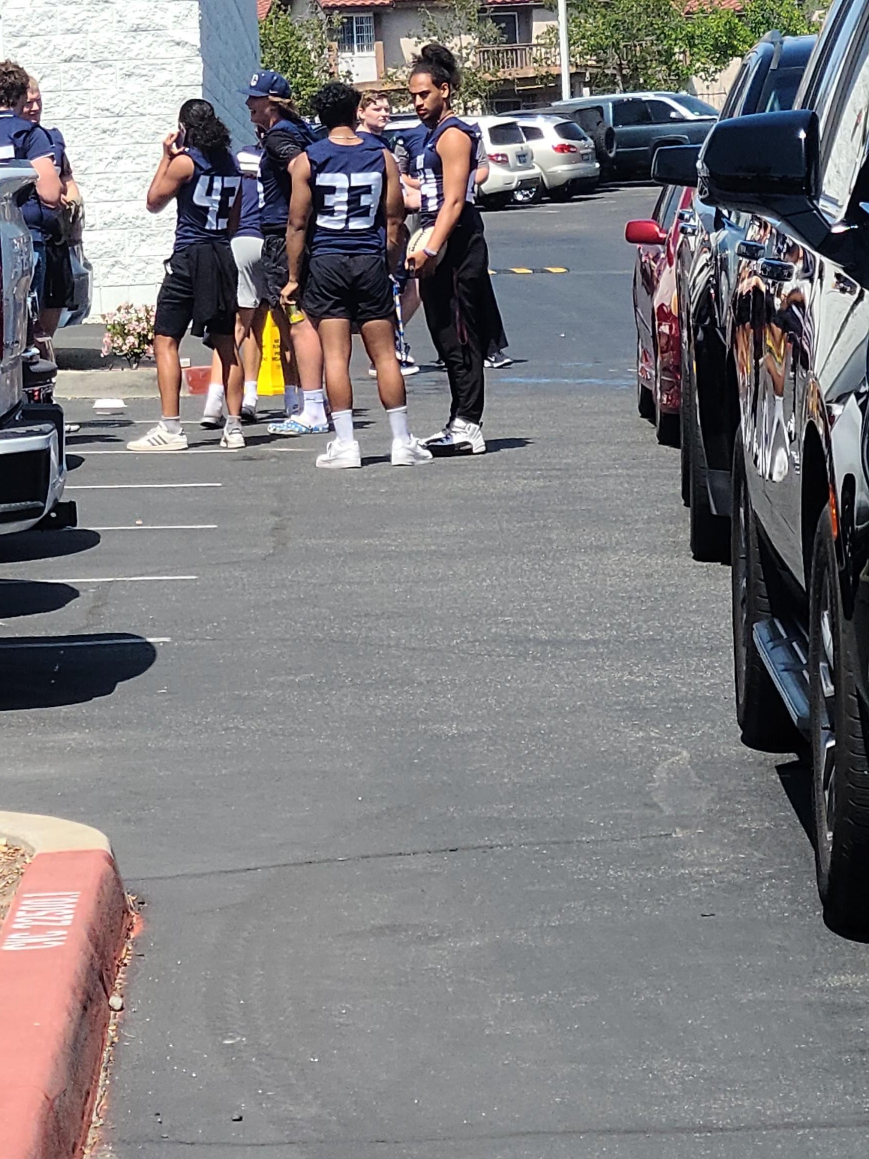 Football players and cars at the USC Chapparal Football Event